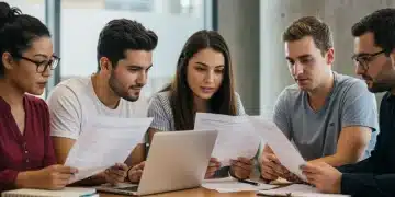 Students reviewing federal student loan repayment plans on laptops